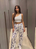 White blue pants with white one shoulder top